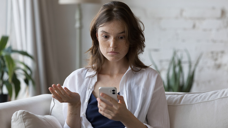 A confused woman on phone