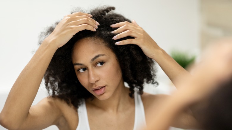 Woman looking at her scalp
