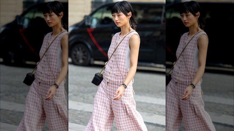 Woman wearing tweed overall romper