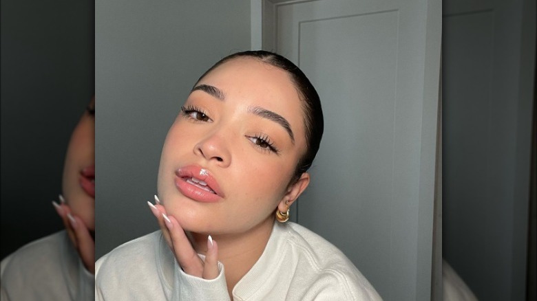 Woman wearing clear lip gloss