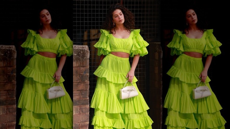 woman wearing green tiered maxi skirt
