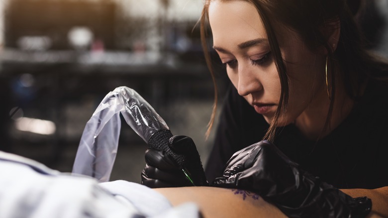 tattoo artist working