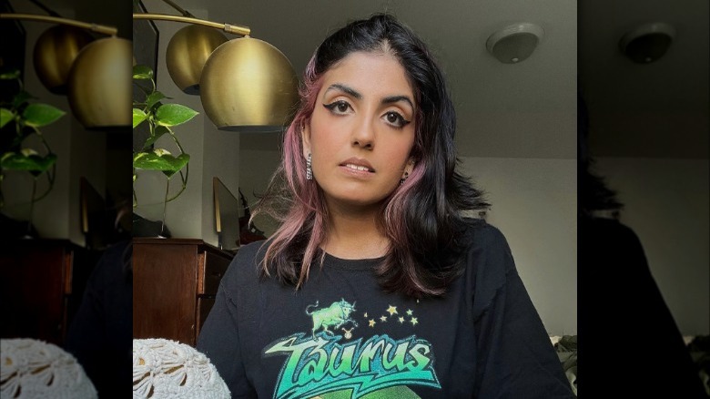 Woman with black hair, pink underlayer