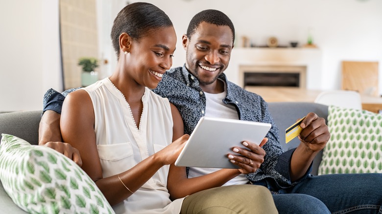 Couple sitting on couch and smiling
