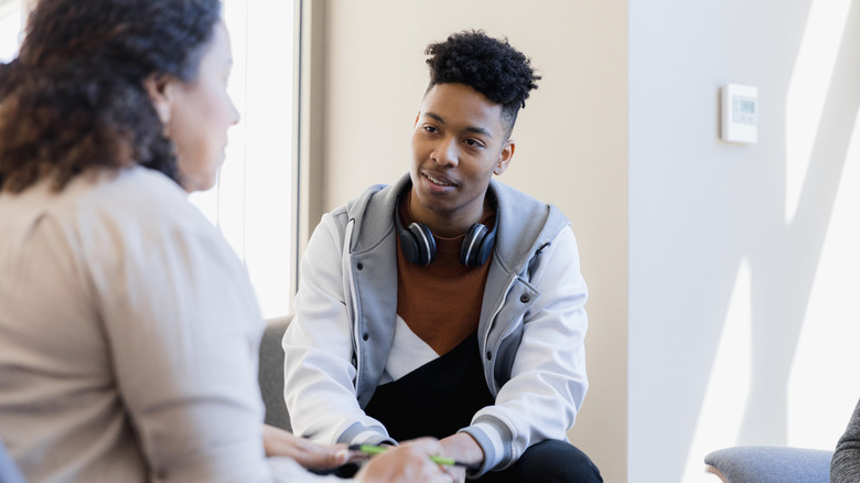 Two people speaking in therapeutic setting