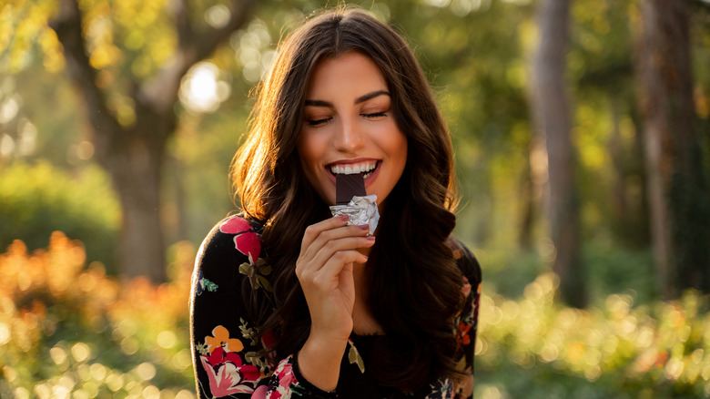 Woman eating dark chocolate