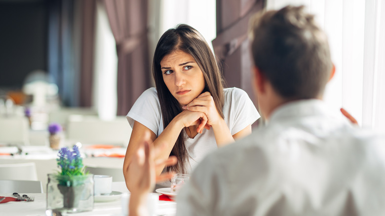 Woman looking confused talking with date