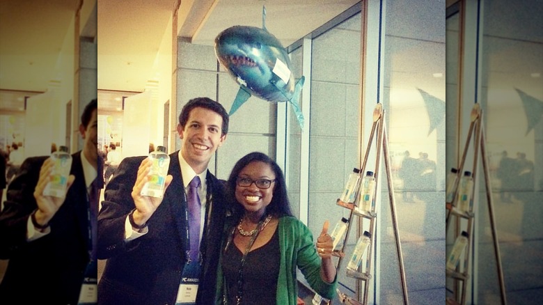 Nate Barbera and Desirée Stolar posing with their product