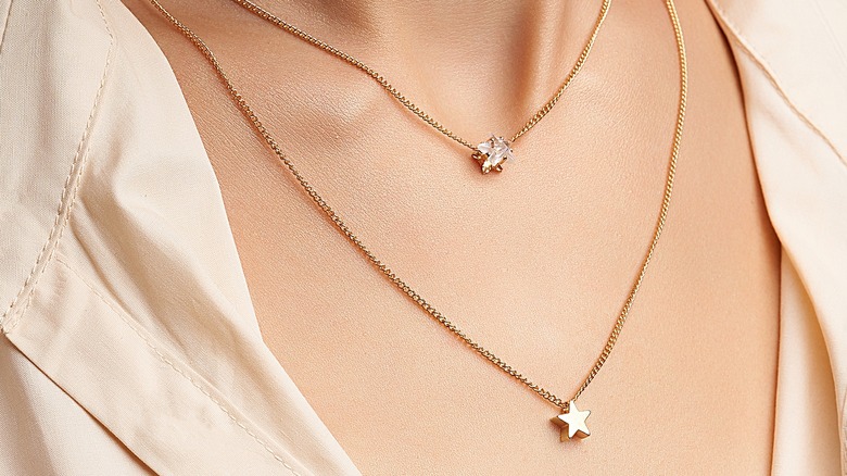 Woman wearing two simple necklaces