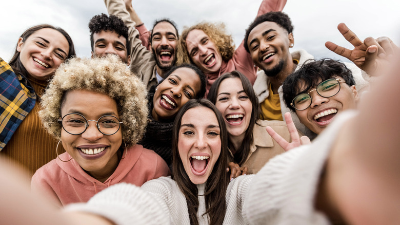 Woman taking selfie with friends