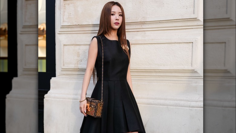 Woman in LBD, brown accessories