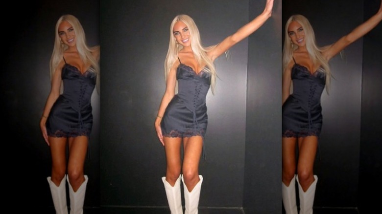 Woman in LBD, white boots