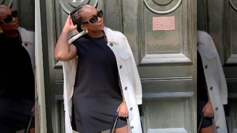 Woman wearing LBD, white coat