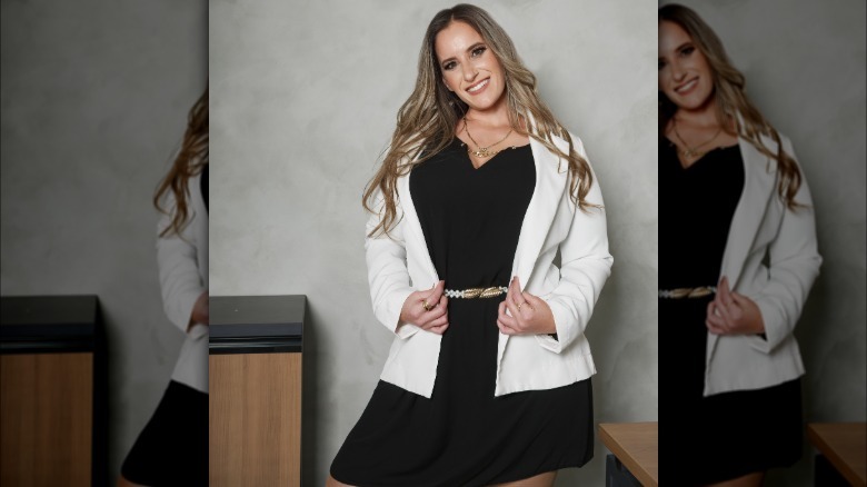 Woman in LBD, blazer, sunglasses