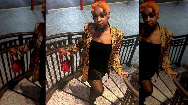 Woman wearing gold blazer, LBD