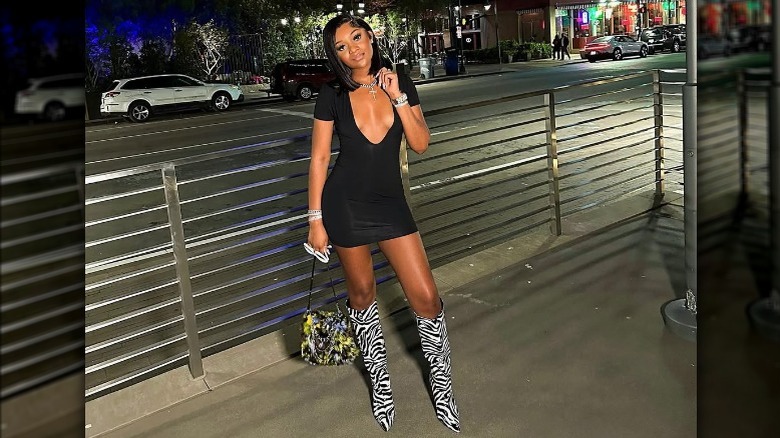 Woman in LBD, animal-print boots