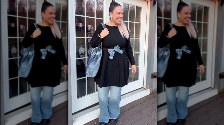 Woman wearing LBD over jeans