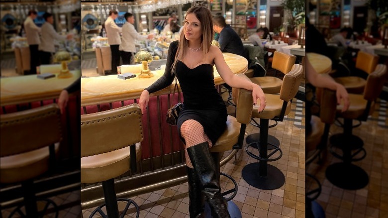 Woman in LBD, tall boots