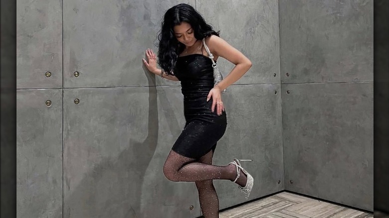 Woman leaning against wall