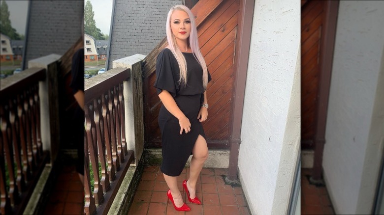 Woman in LBD, red heels