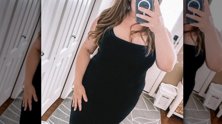 Woman in black, taking selfie