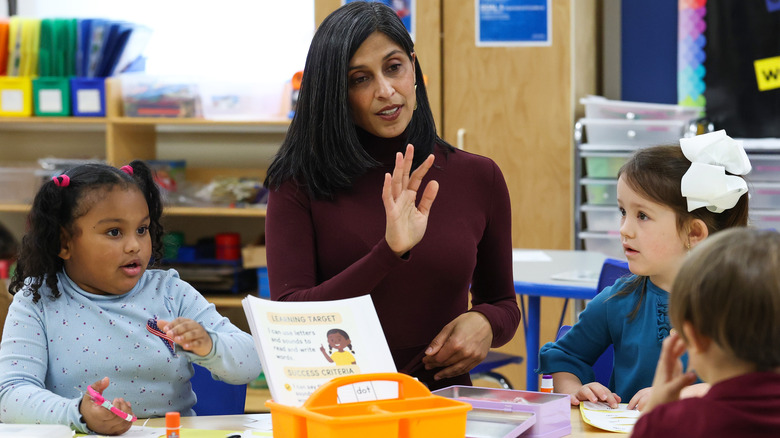 Usha Vance sitting with children in school