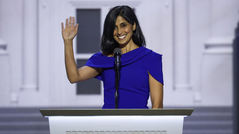 Usha Vance waving in a blue dress at a podium