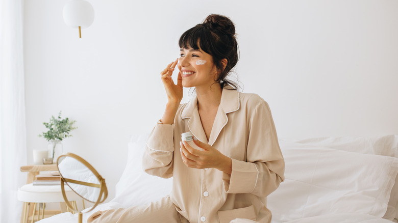woman applying skincare cream