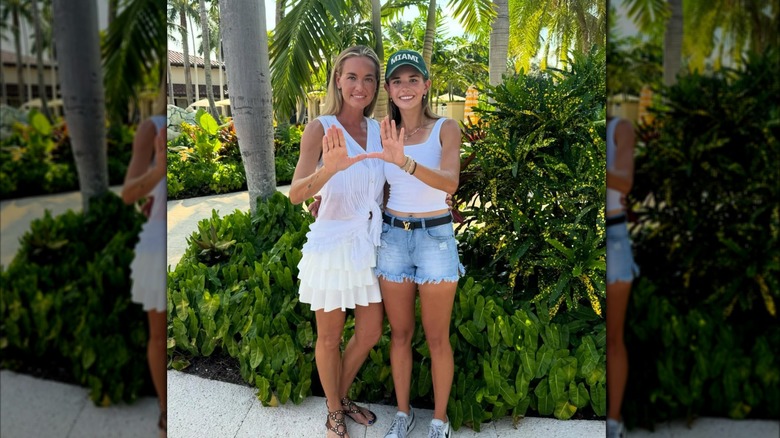 Vanessa and Kai Trump posing in white, with Kai wearing denim shorts