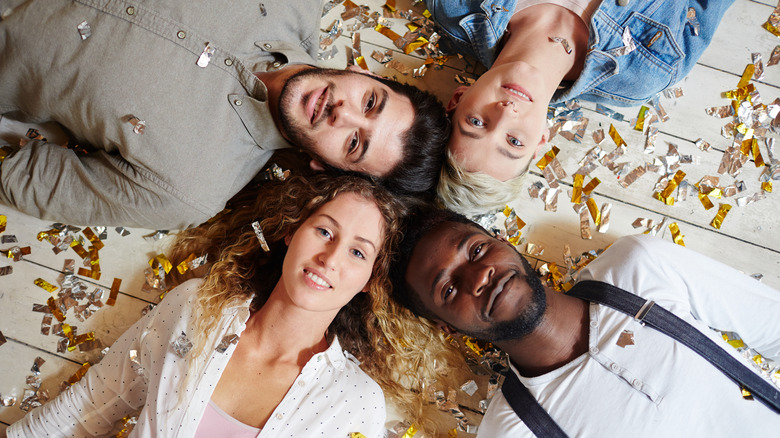 Foursome on floor, heads together