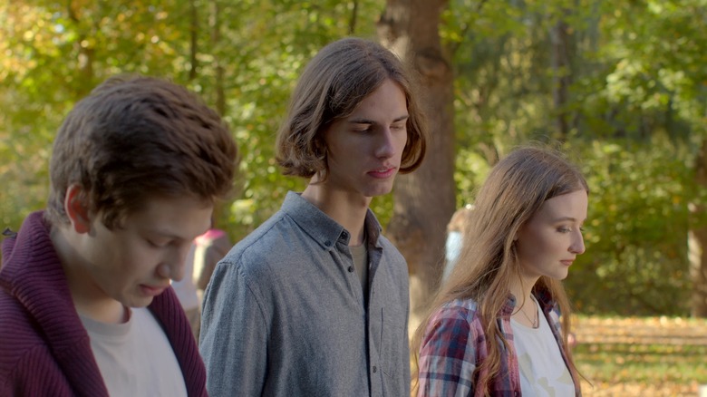 Two men, one woman looking upset