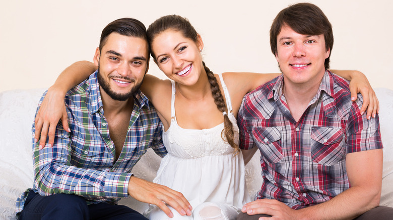 Throuple sitting on the couch