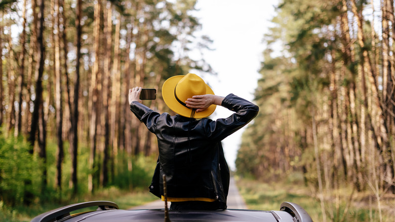 woman wearing leather taking selfie