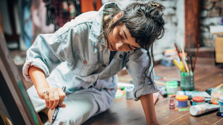 Woman painting in studio