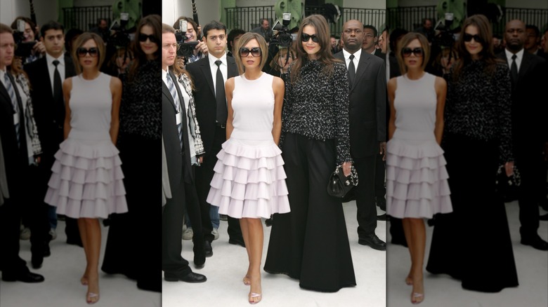 Victoria Beckham and Katie Holmes posing for cameras at the Chanel show for Spring/Summer 2007 during Paris Fashion week (2006)