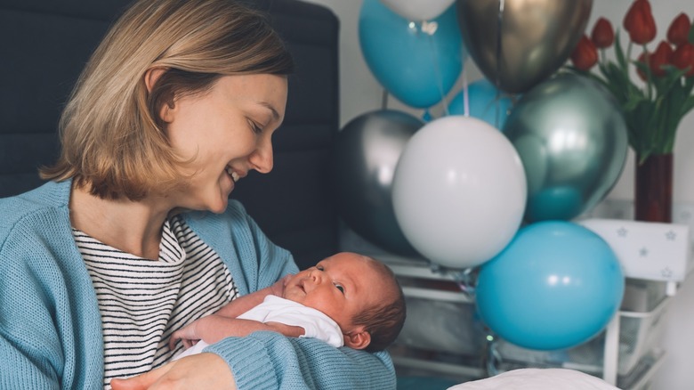 A woman cradles her newborn son.