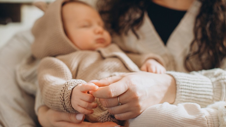 A woman holds her baby.