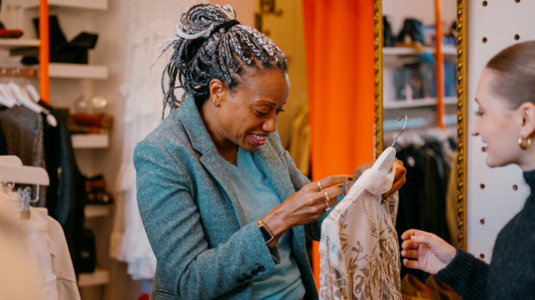 Woman looking at a label on a blouse