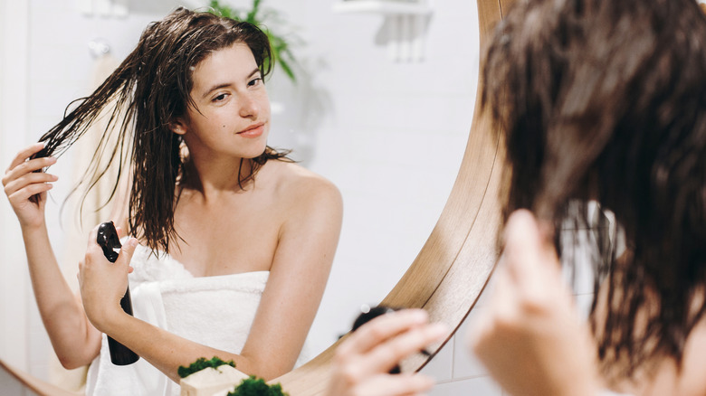 Woman spritzing hair