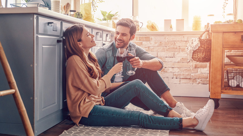 couple sharing wine on floor
