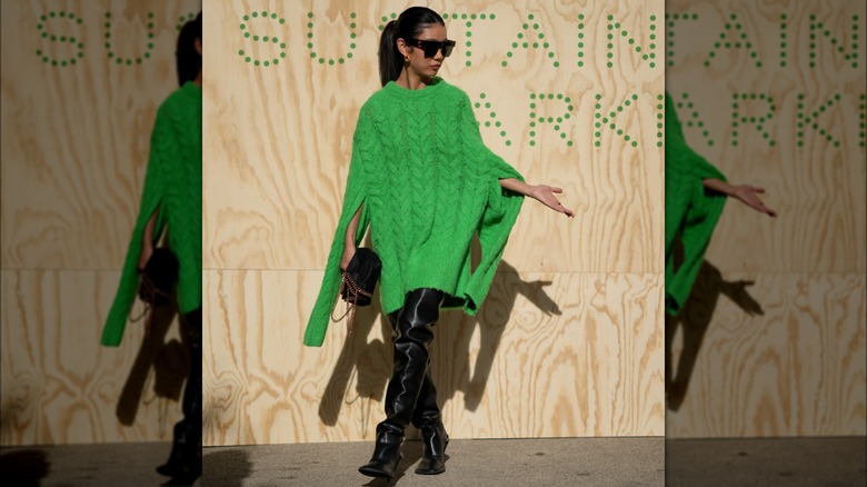 woman wearing sweater dress and boots