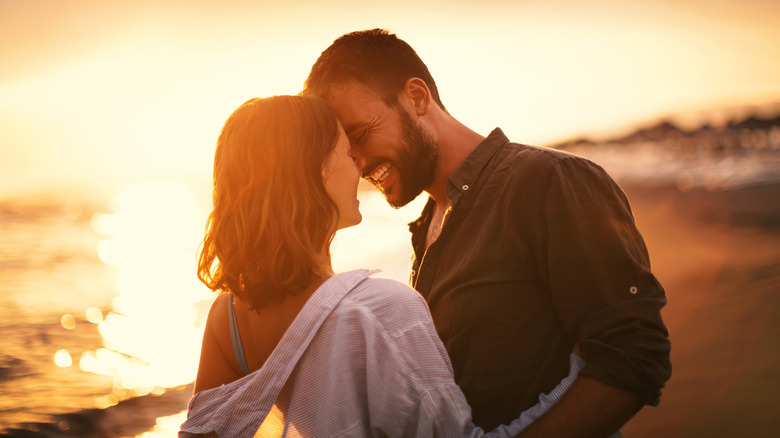Couple smiling by the beach