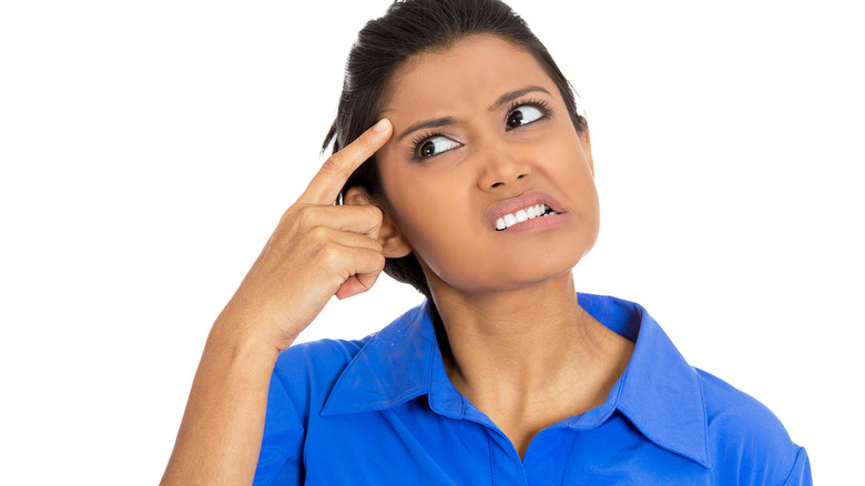 woman tries to remember something