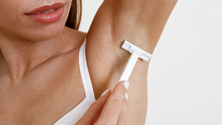 Woman shaving arm pit