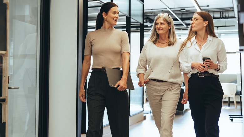 women walking around office