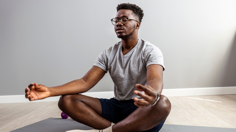 Man meditating on a mat
