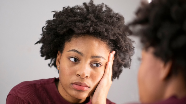 African American woman looking in the mirror