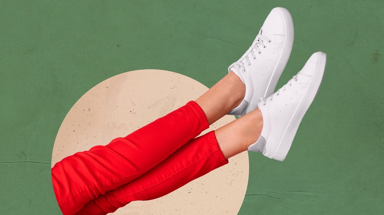 Woman's legs wearing white shoes