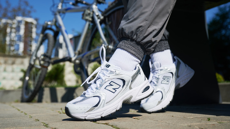 Someone wearing New Balance cross trainer sneakers
