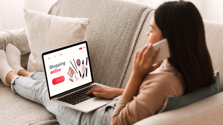 Woman shops for makeup on laptop